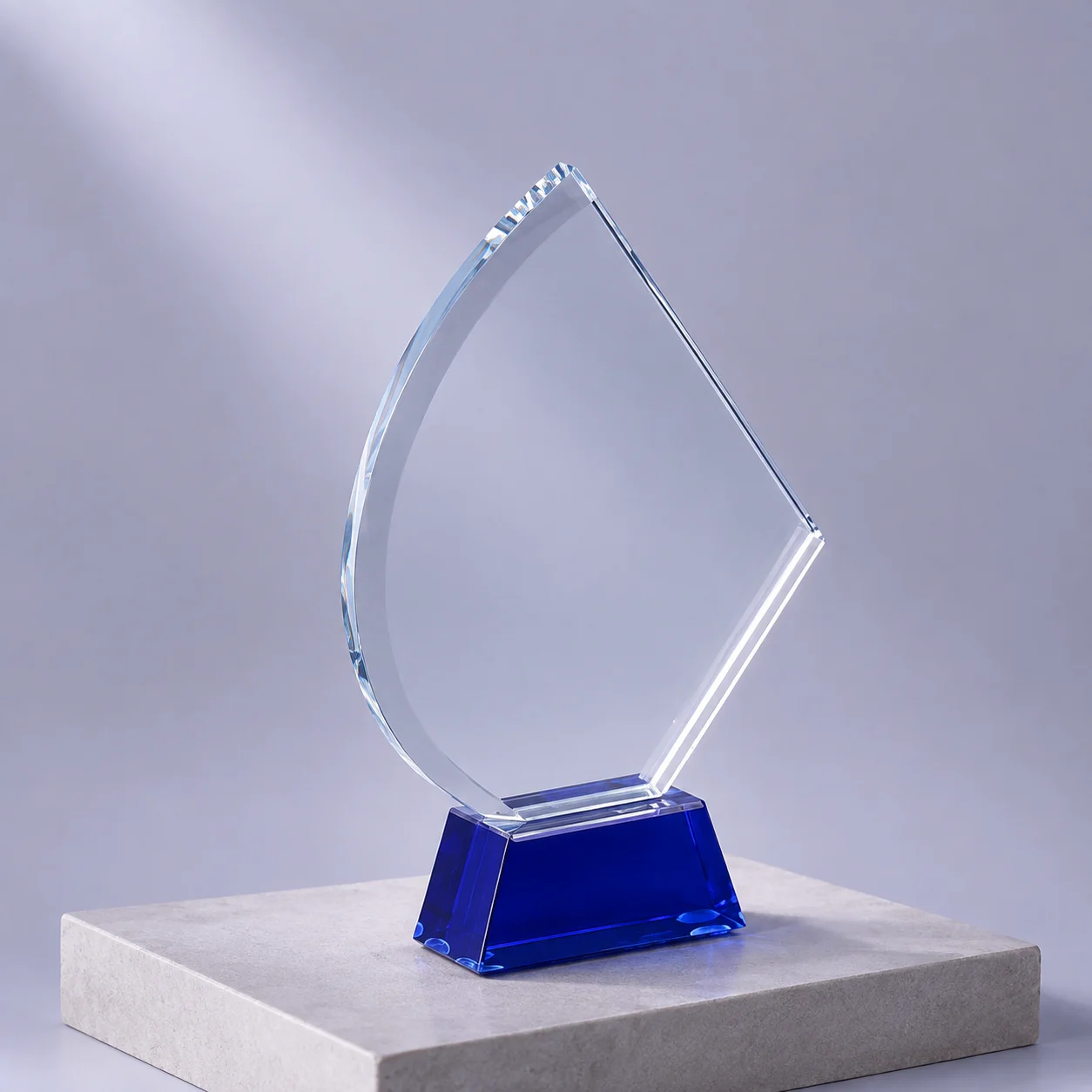 Bespoke crystal award with a sweeping curve and a deep blue base